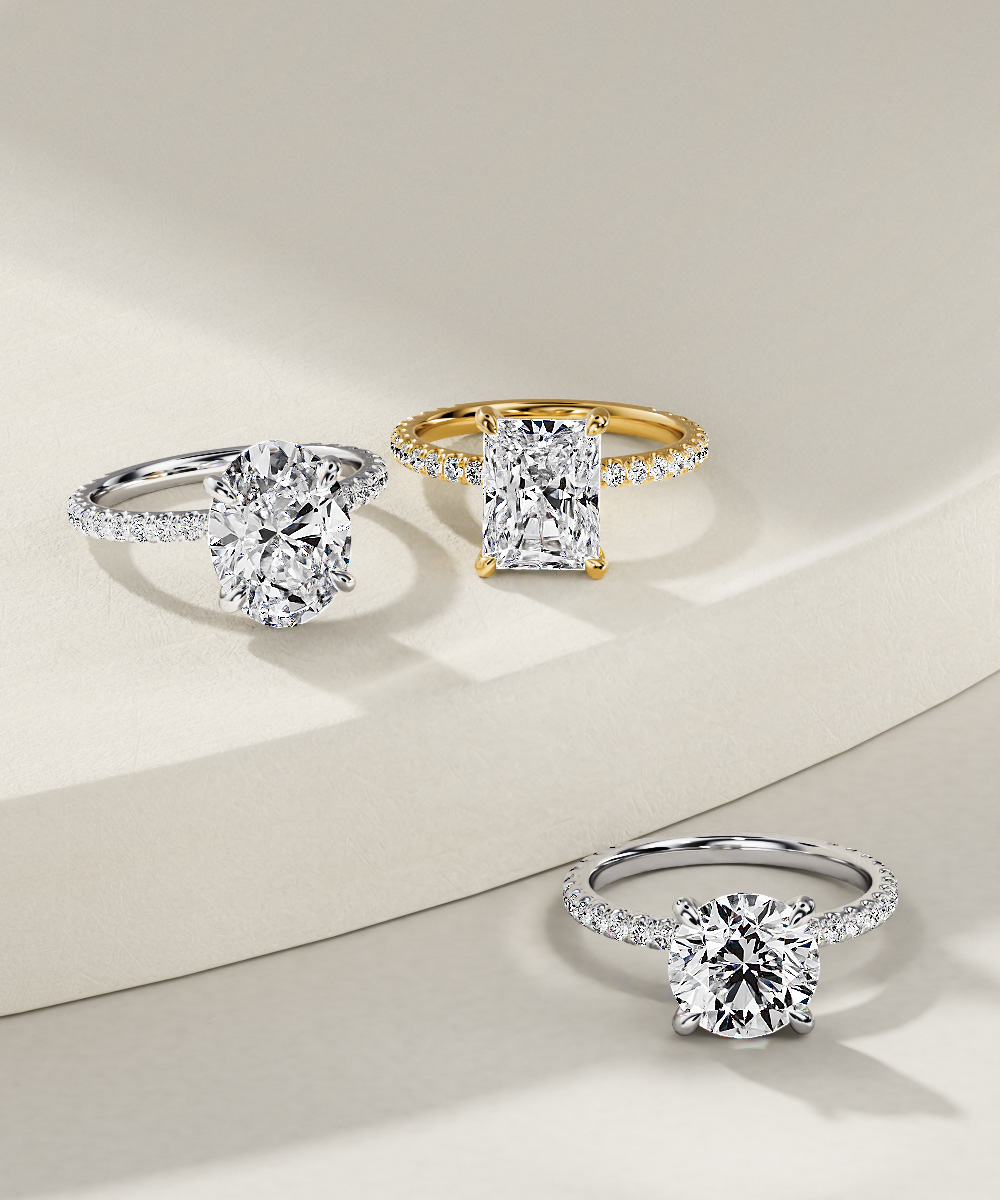 Jewelry rendering: Assorted diamond engagement rings in yellow and white gold.