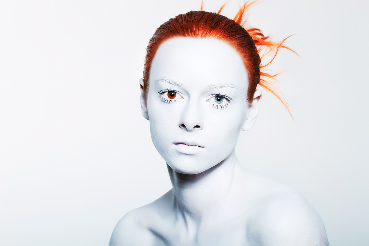 White facepaint makeup eyes redhead different color eyes Heterochromia negative space soft light portrait girl
