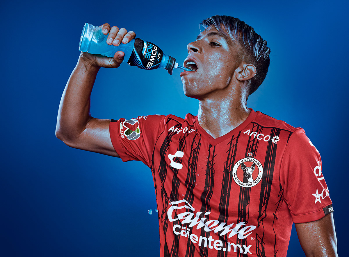 Portrait of Ángel Sepúlveda Mexico's soccer player stand drinking Powerade
