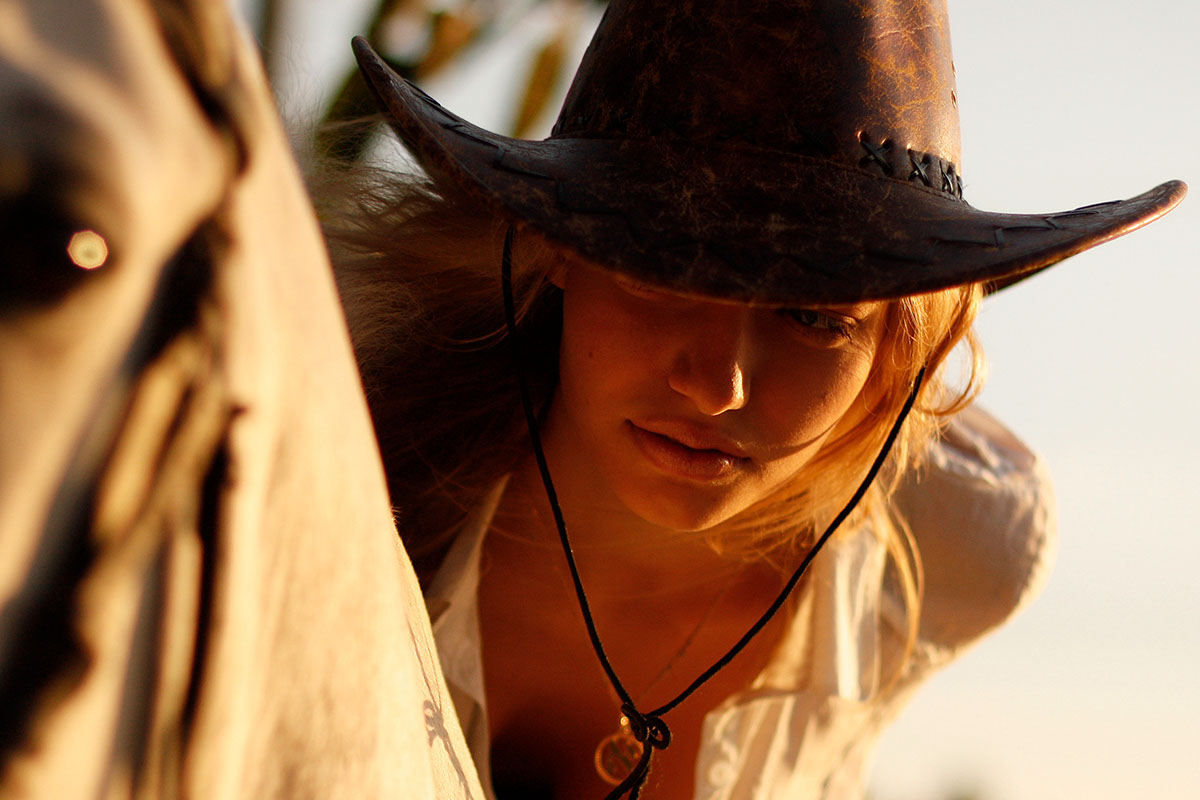 horse racetrack cowboy hat sunset field