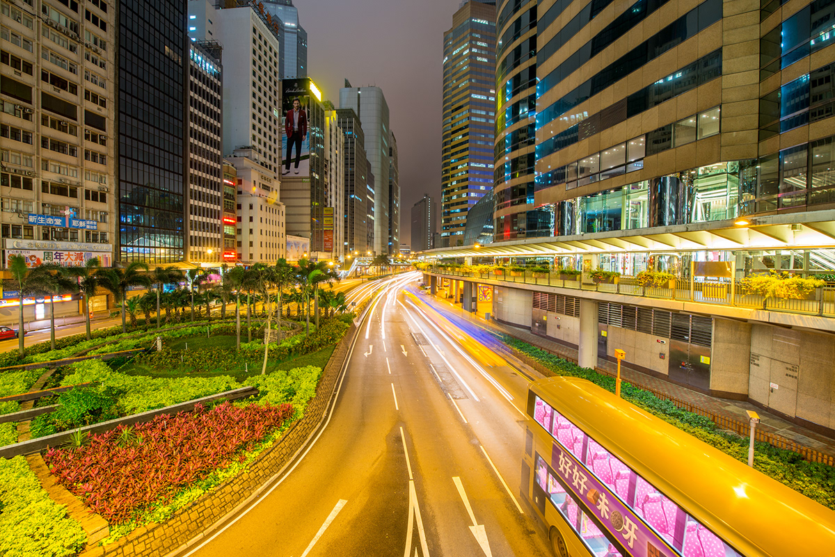 Hong Kong streets night traffic lights buildings skyscrapers skyline light trails