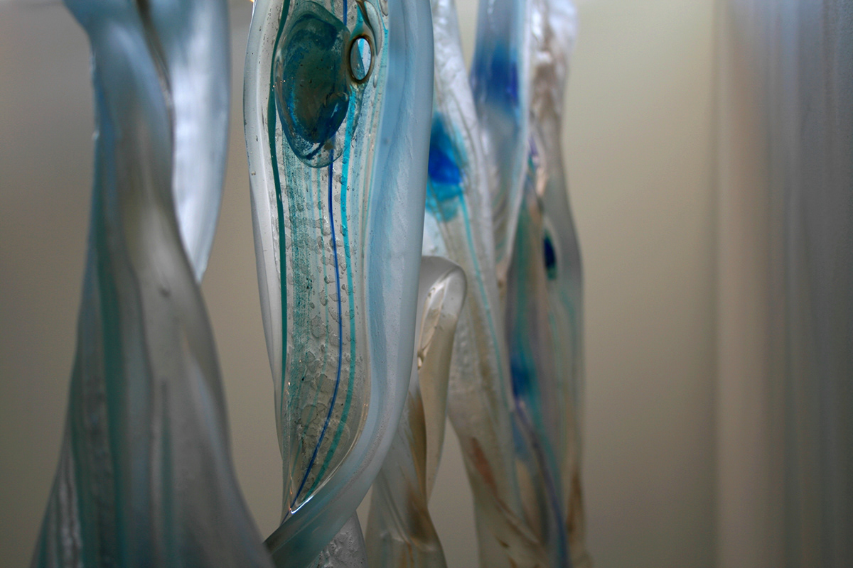glass installation suspended hanging seaweed pods Cane spheres blue transparent Room Divider window art sculpture fluid