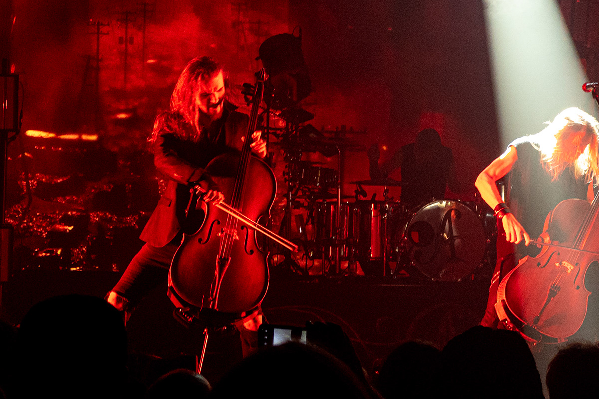 Two men playing rock/metal cello on stage