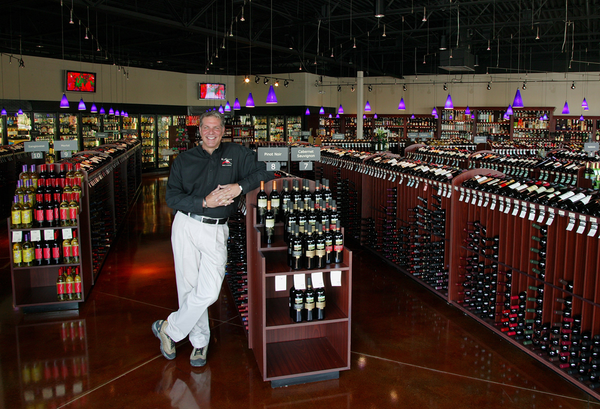 corporate portrait wine Liquor Store wine rack people business owner wine store speciality wine portraits wine & spirits womens suits business attire corporate lighting business