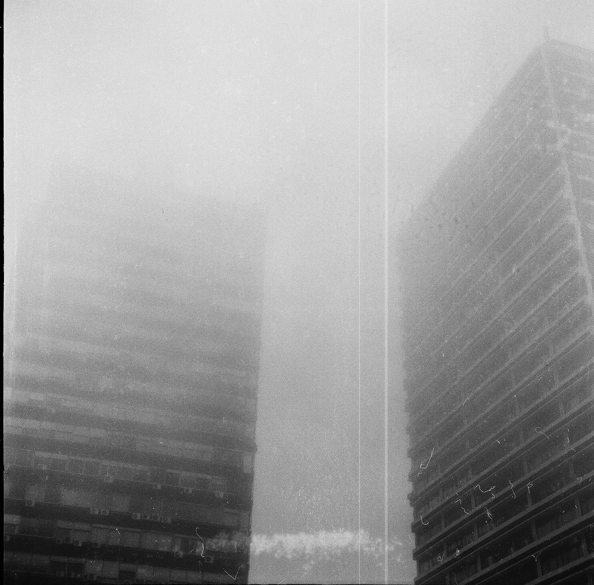 Image may contain: fog, black and white and skyscraper