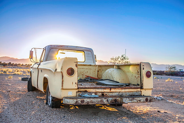 California desert auto graveyard sunset trona yellow truck dodge pickup