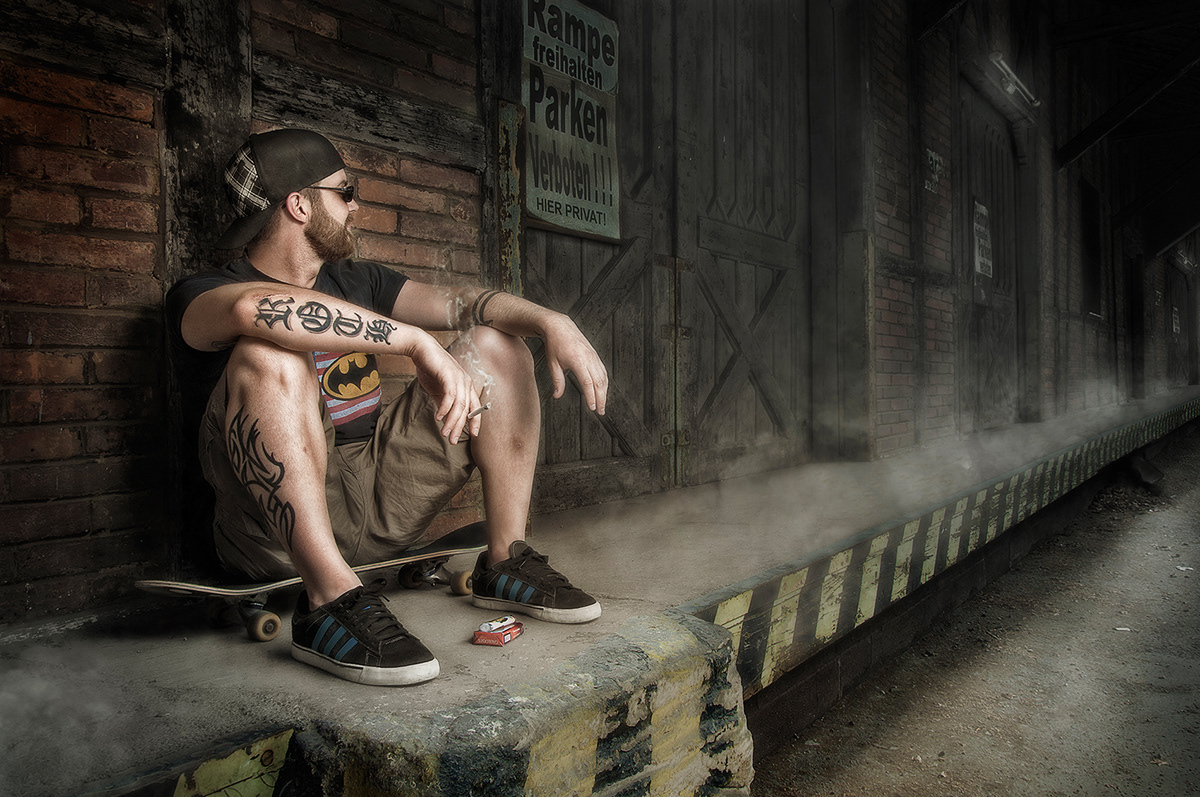 man Outdoor tattoo skate smoke