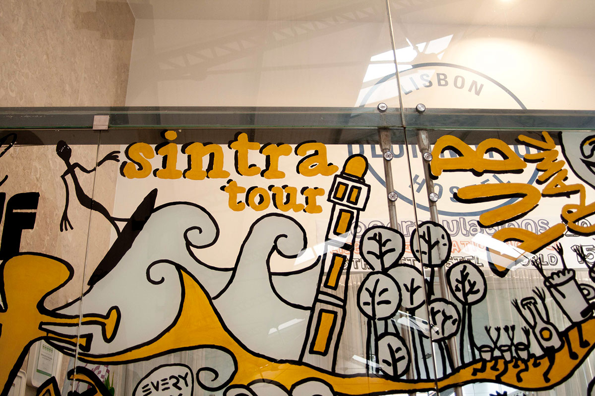 glass door painting yellow lisbon destination hostel lisbon destination tours