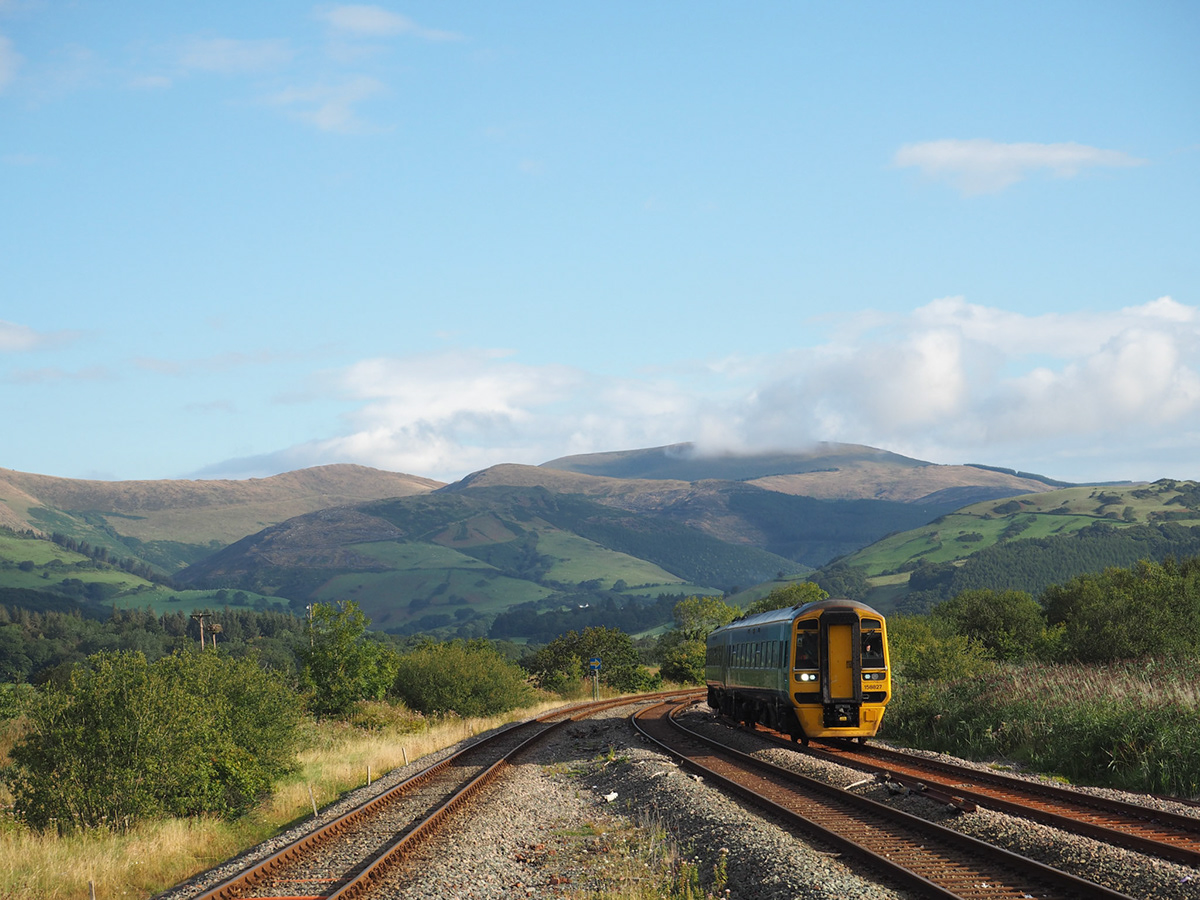 blue clouds green hills SKY sublime tracks train wales Travel