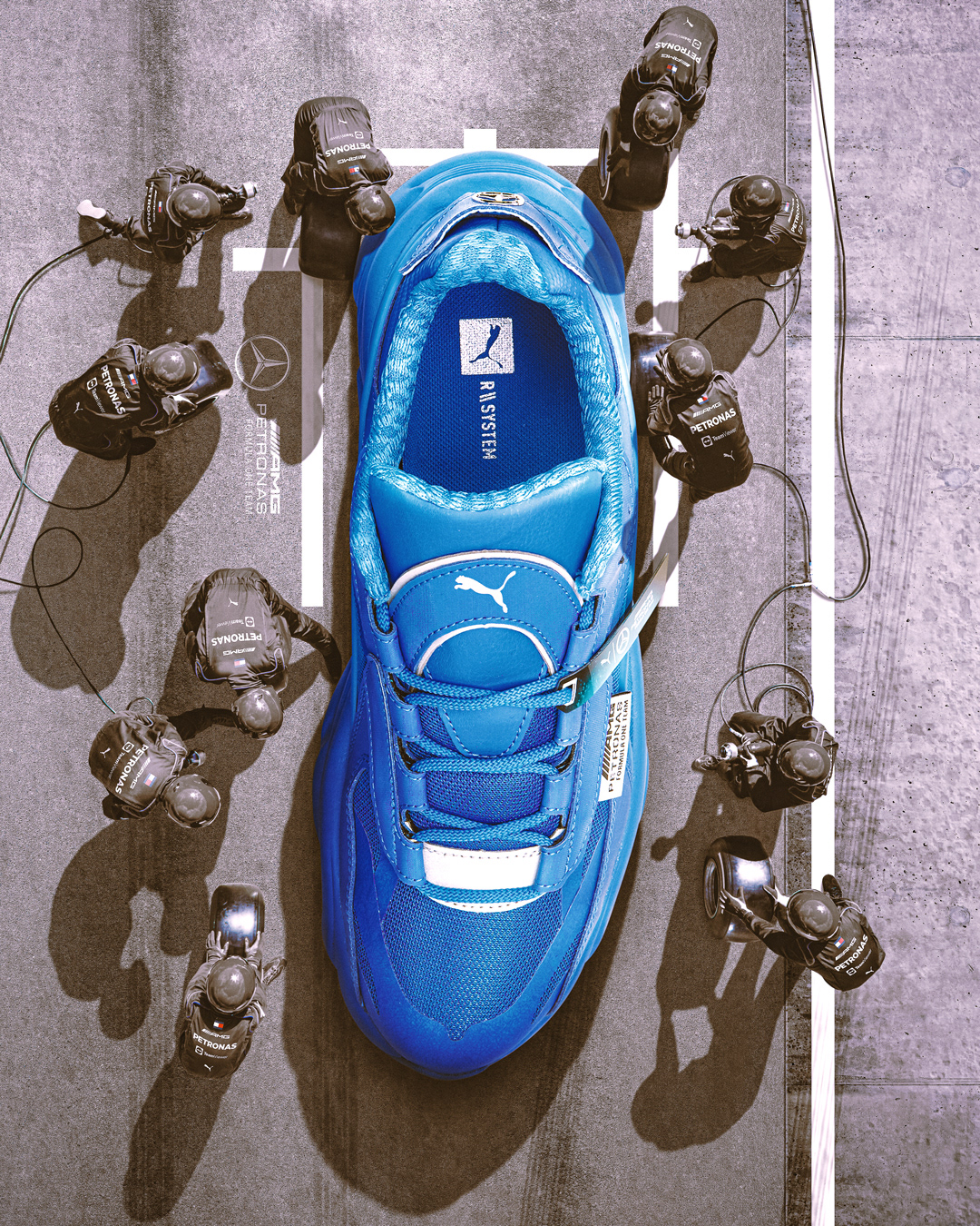 This is a Photoshop composite of a giant Puma sneaker at a Formula 1 pitstop.