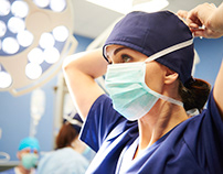 Female Surgeon Tying Wear Surgical Mask