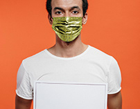 Man in a Face Mask Holding the Poster Free PSD Mockup