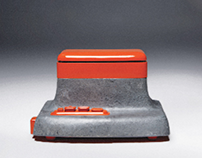An orange - concrete speaker