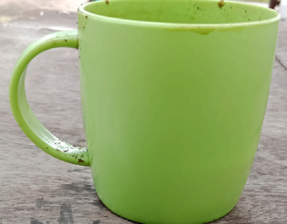 A green mug color on plaster background