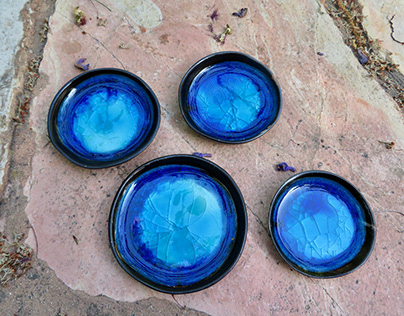 Blue ceramic saucers glazed with colored glass