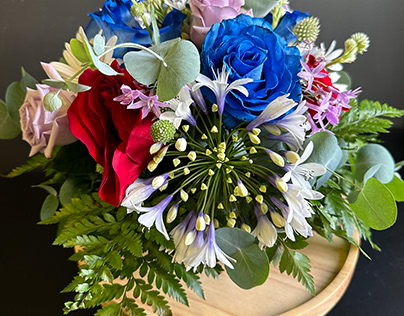Red, Blue, Purple Rose Arrangement with Daisies