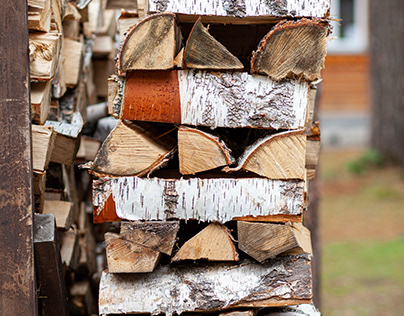 Neatly folded woodpile of birch firewood in the village