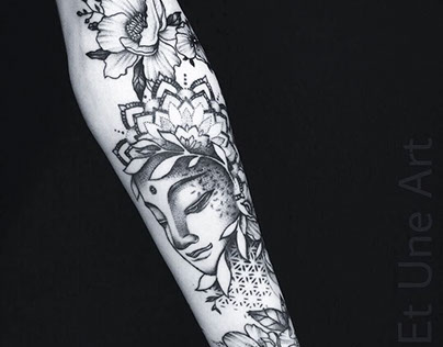 Buddha floral arm tattoo