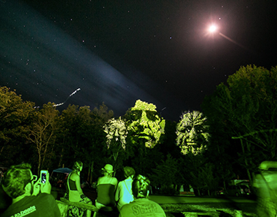Blink Twice: 3D motion faces projected on trees. 