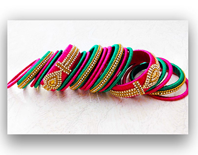 GREEN AND PINK SILK THREAD BANGLES WITH EMBLISHMENTS