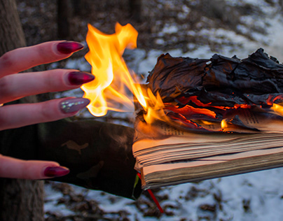 Witch burns her book