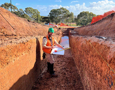 Trench being examined by a geologist