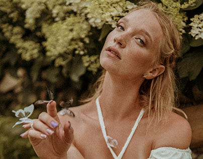 Girl in the garden with butterflies