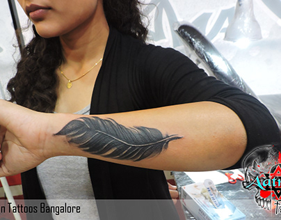 FEATHER TATTOO GIRL DONE BY AATMAN TATTOOS BANGALORE