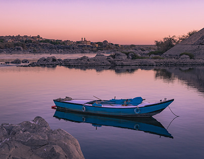 sunset over fishing boat at Nile water