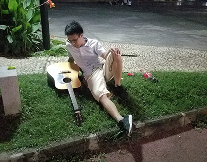 Student with guitar at night