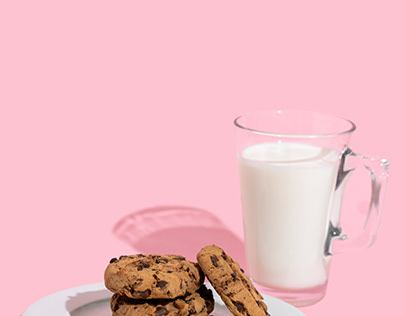 Plate with chocolate chip cookies and glass of milk