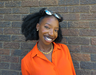 African black woman in orange smiling