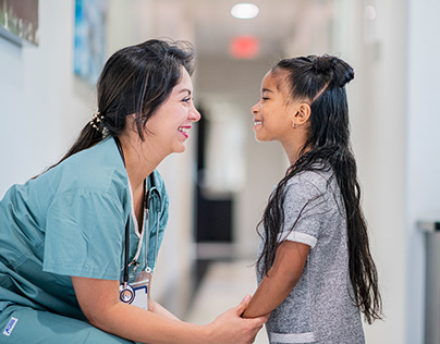 Female Doctor Talking to Little Patient