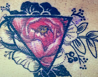 Flower in triangle tattoo