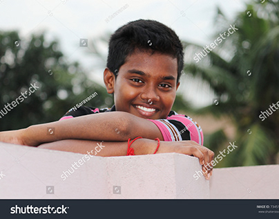 Indian teenage boy posing his pleasant smile