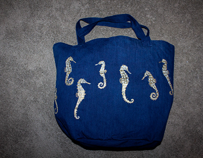 Hand-painted seahorse design on a denim tote bag
