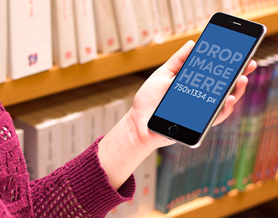 Mockup of Girl Using iPhone 6 Plus at the Library