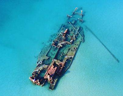 Aerial view of old stranded ship in the sea