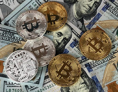 Bitcoins on top of dollar bills