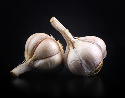 Close-up unpeeled garlic on black background
