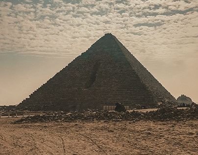Lesser Pyramid of Giza peaks through clouds.