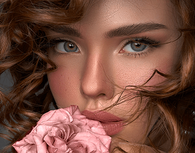 Green eyed handsome woman with nude makeup and flower