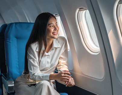Asian woman sitting in a seat in airplane #logodesign