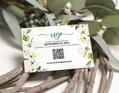 Wedding RSVP card with white roses and greenery