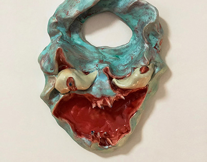 Laughing ceramic monster face