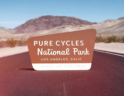 Pure Cycles National Park Sign