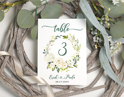 Table number design with white roses and greenery