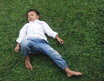 A Child lie on the grass