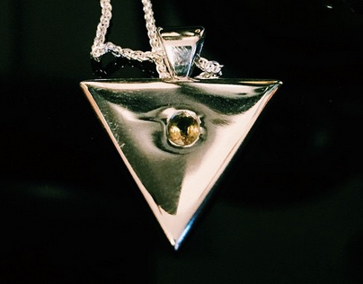 Silver triangle pendant with green sapphire by Howl