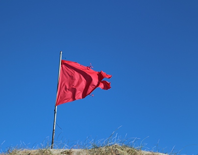Red flags on blue sky